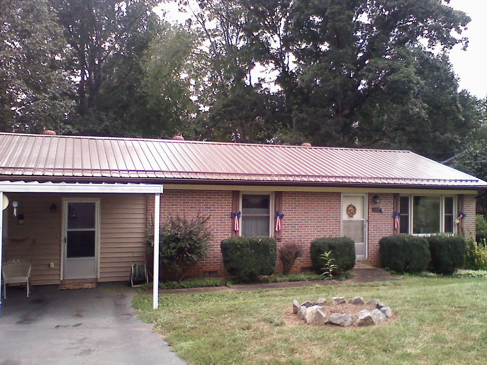 Bronze metal roof and carport on a brick ranch home — Roof Repair work by our crew in Zarephath